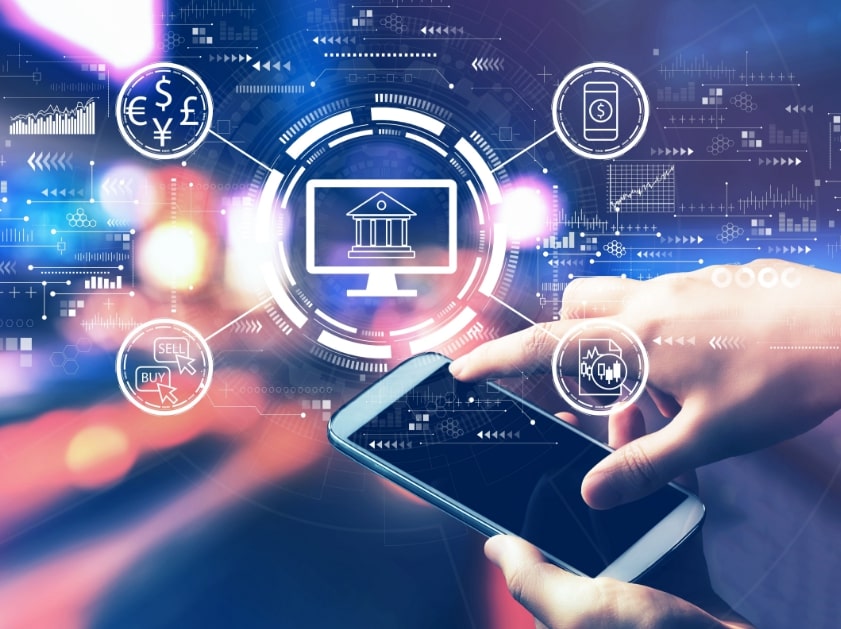 Banking and finance icons around a monitor and a smartphone