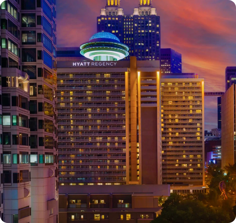 Hyatt Regency Atlanta at night in Downtown Atlanta, venue for the Infocepts Happy Hour at Databricks World Tour Atlanta 2026